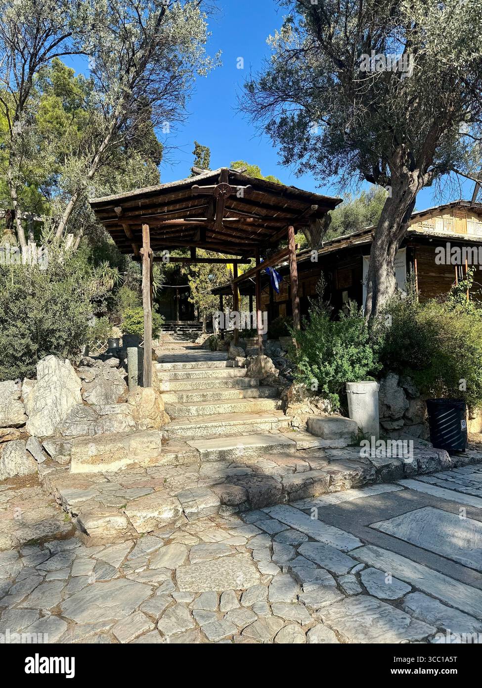 St Demetrios Loumbardiaris Church surrounded by greenery and clear blue sky - Smartphone Captured Stock Image