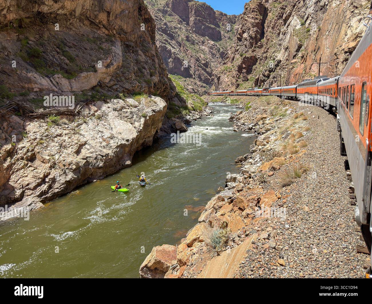 Canon City, Colorado, USA - 22 May 2025: Scenic landscape view of a train on Royal Gorge Route Railroad alongside the Arkansas River with kayakers - Smartphone Captured Stock Image