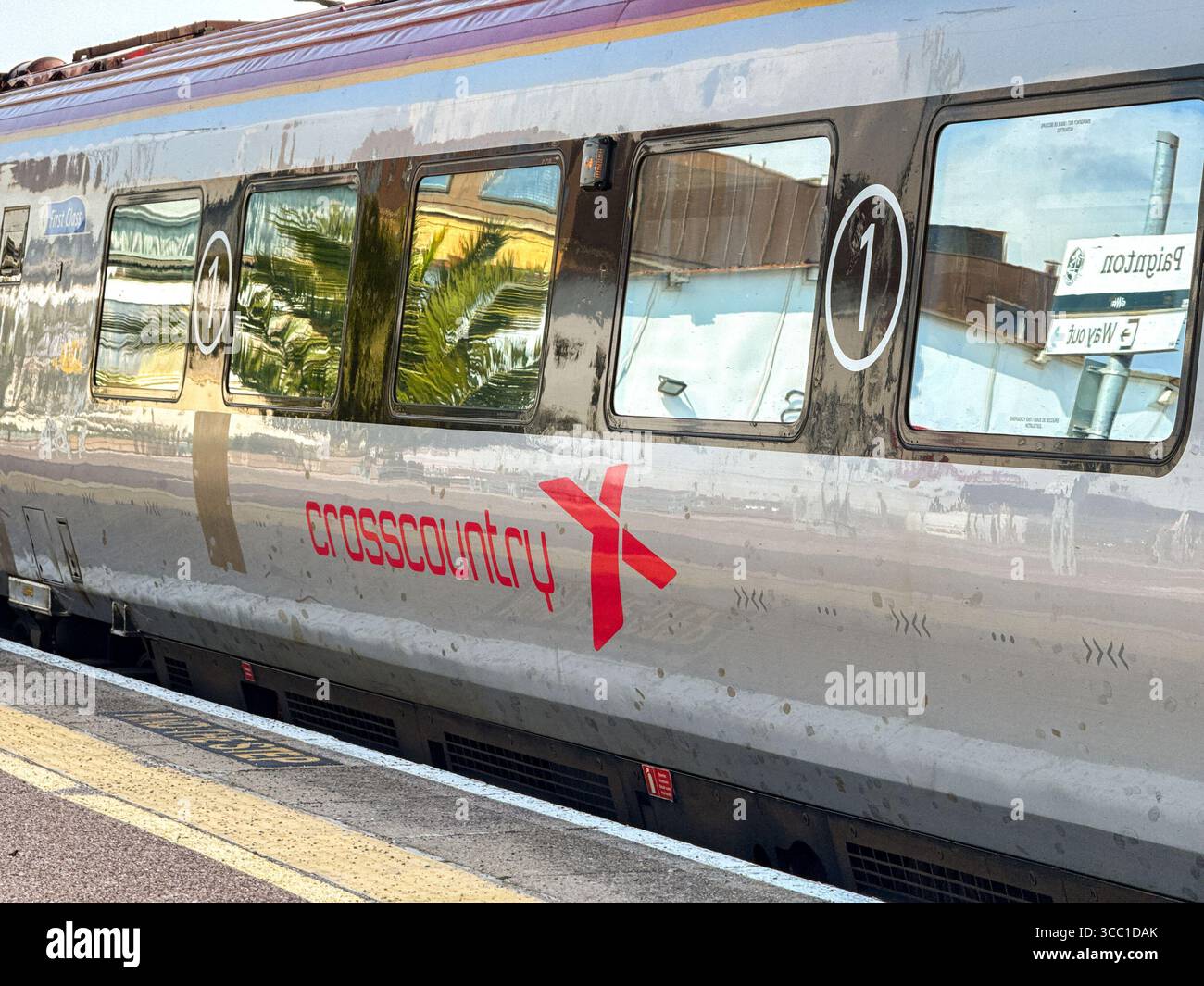 Paignton, Devon, England, UK - 24 April 2025: Side view of a coach on a train operated by Cross Country at at Paignton Railway Station. - Smartphone Captured Stock Image