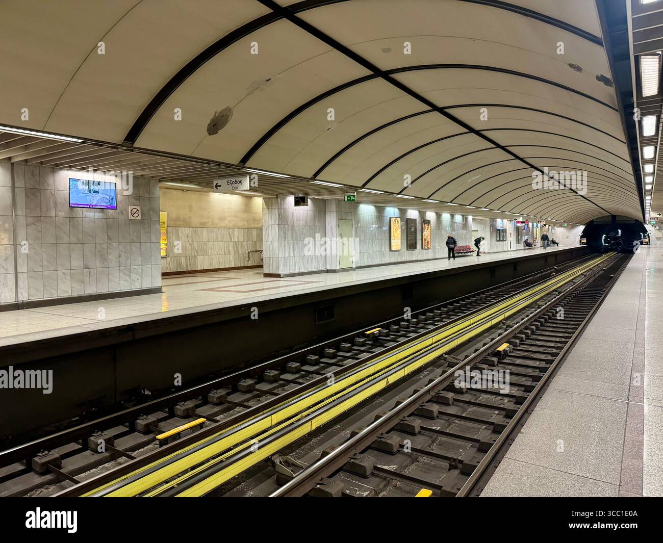 Modern metro station platform in Athens, Greece, with empty tracks and curved ceiling design. - Smartphone Captured Stock Image