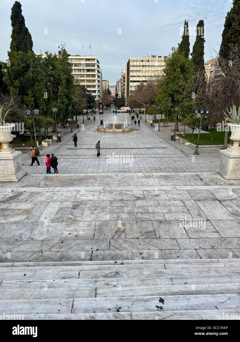 View of Syntagma Square, the central plaza of Athens, Greece, with pedestrians and surrounding greenery. - Smartphone Captured Stock Image
