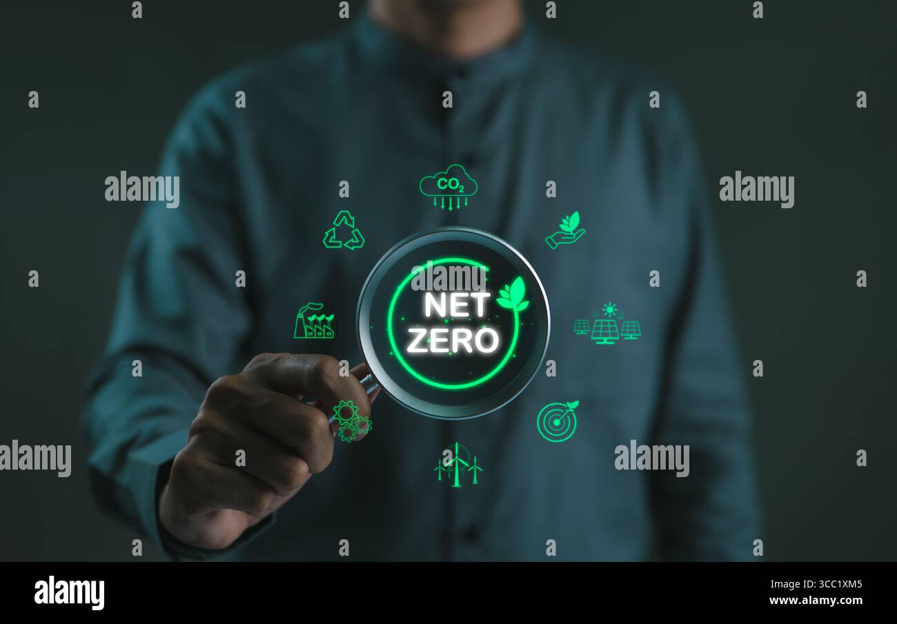 Net Zero emission concept. Man holding magnifying glass to carbon ...