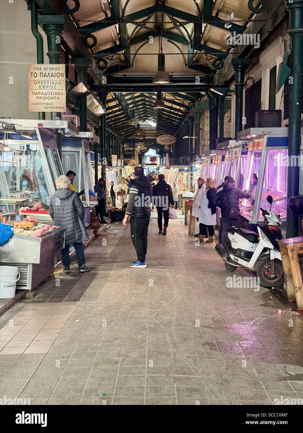 Traditional meat market scene in Athens, Greece, with vendors and shoppers. - Smartphone Captured Stock Image