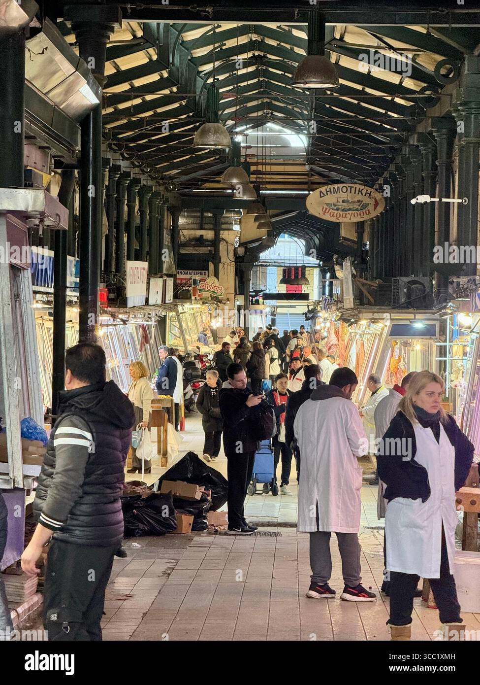 Traditional meat market scene in Athens, Greece, with vendors and shoppers. - Smartphone Captured Stock Image