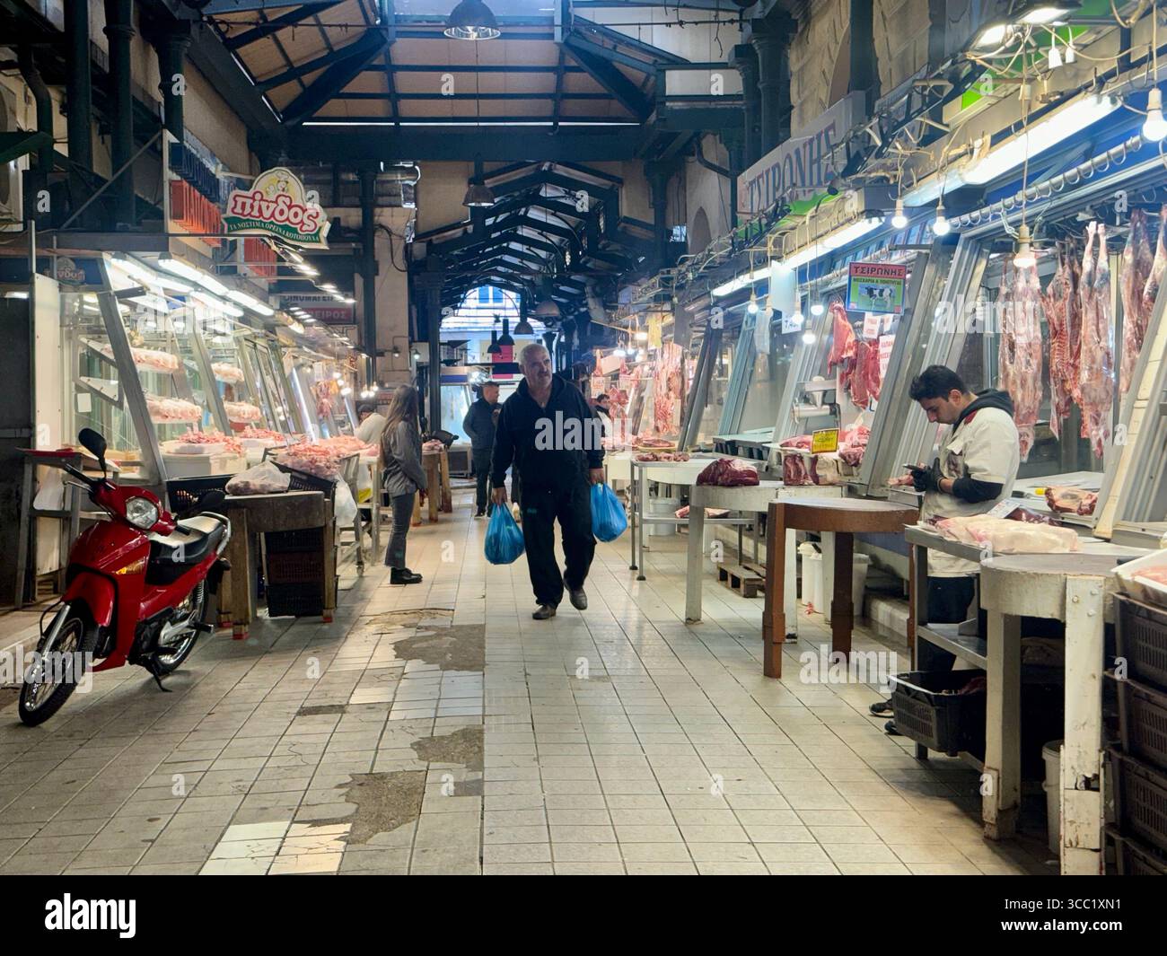 Traditional meat market scene in Athens, Greece, with vendors and shoppers. - Smartphone Captured Stock Image