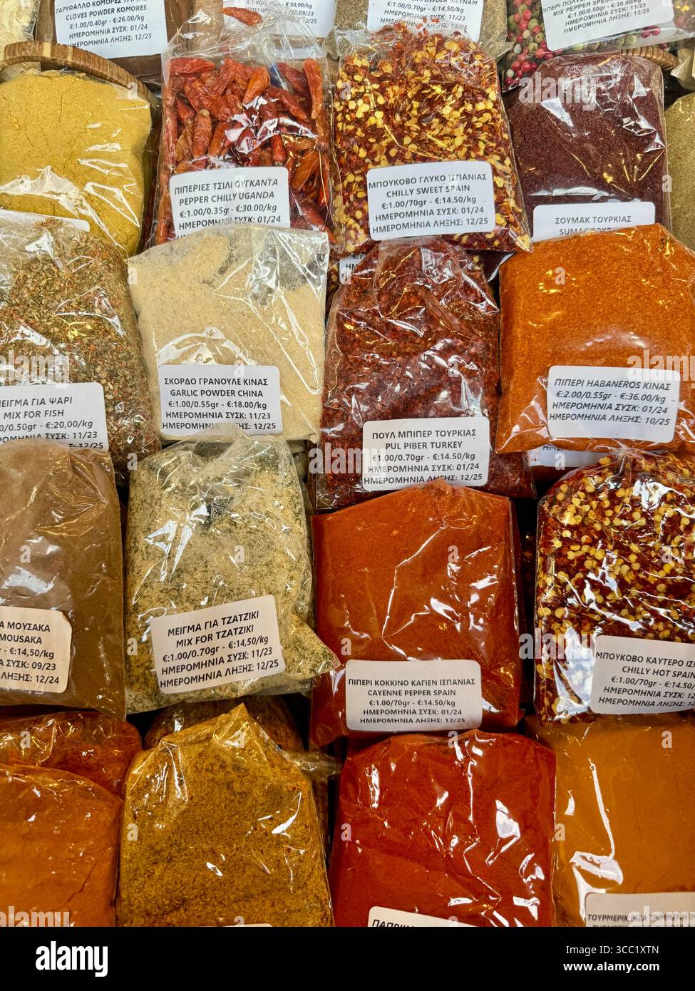 Colorful packets of spices and herbs for sale at a traditional street market in Athens, Greece. - Smartphone Captured Stock Image