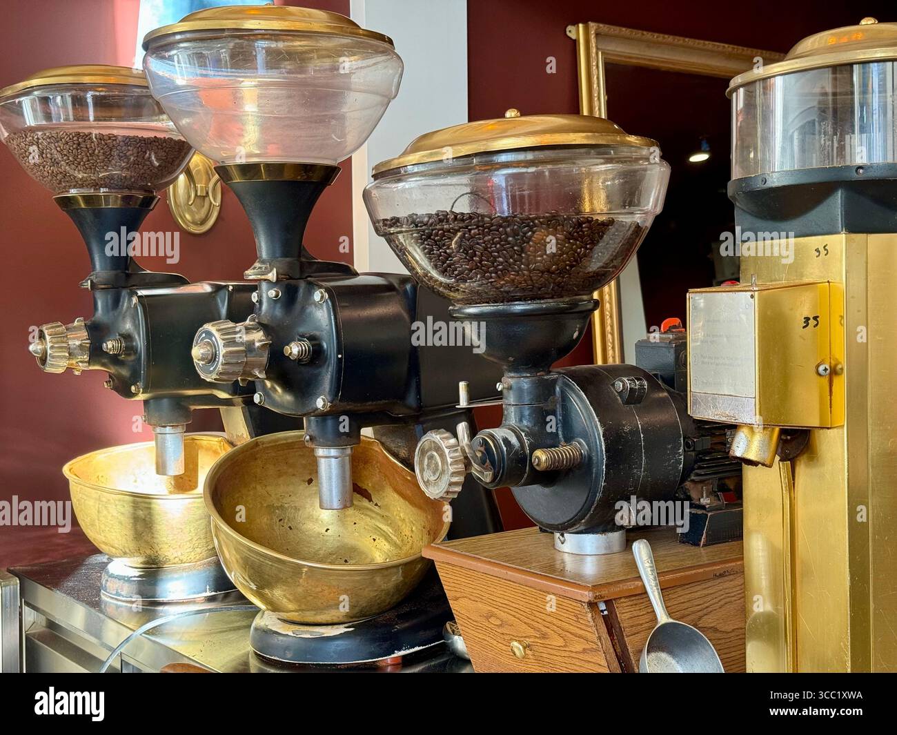 Close-up of vintage coffee grinders in a cafe in Athens, Greece, showcasing the traditional coffee grinding process. - Smartphone Captured Stock Image