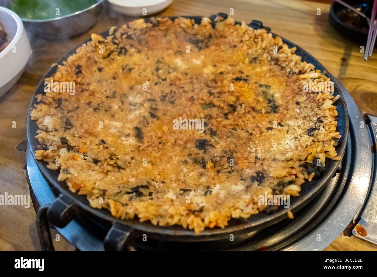 Crispy fried rice on pan, made by mixing rice, seaweed and sauce ...