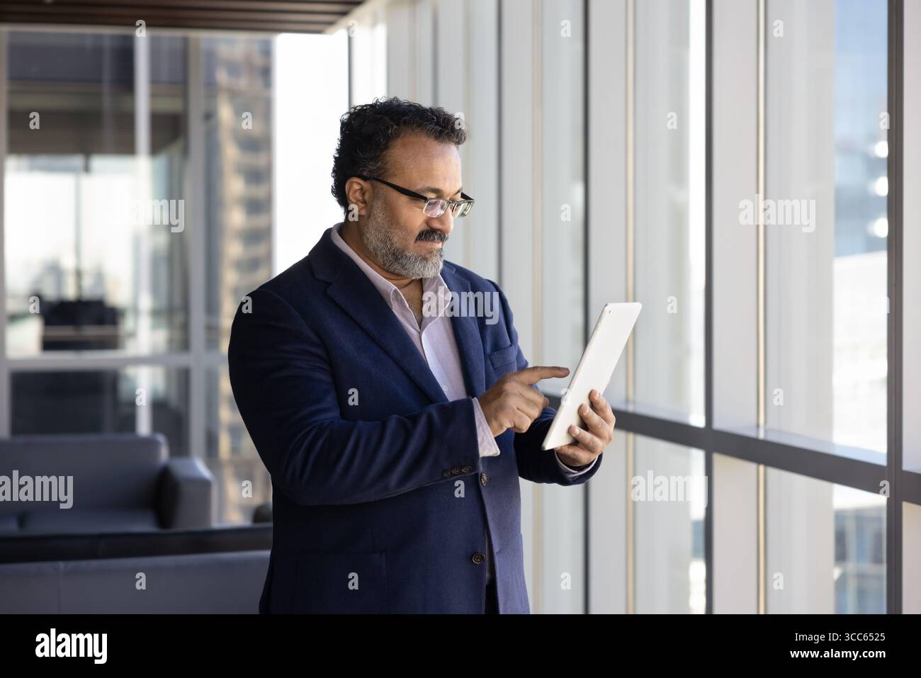 Senior Indian business professional executive man using Internet technology Stock Photo