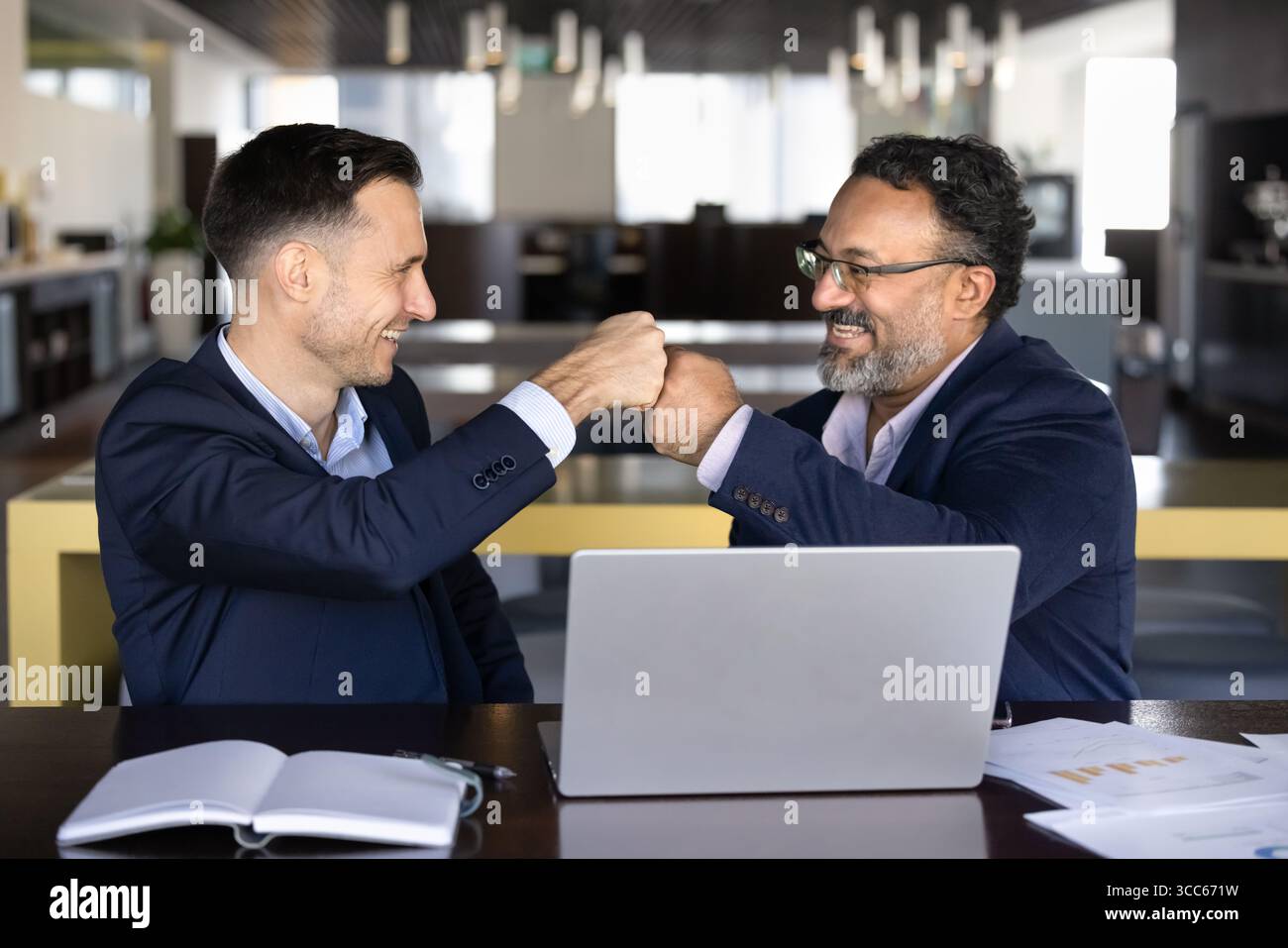 Two happy diverse business colleagues making fist bump hands Stock Photo