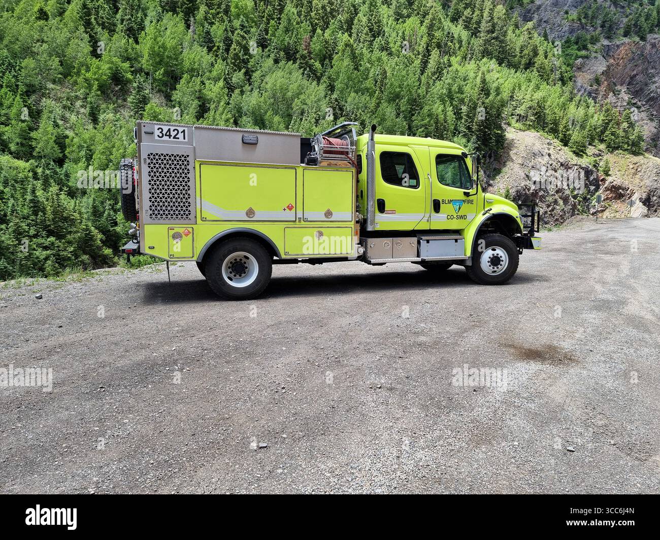 Bright yellow Bureau of Land Management (BLM) fire truck for ultra-fast response, parked in mountainous area in Colorado - Smartphone Captured Stock Image