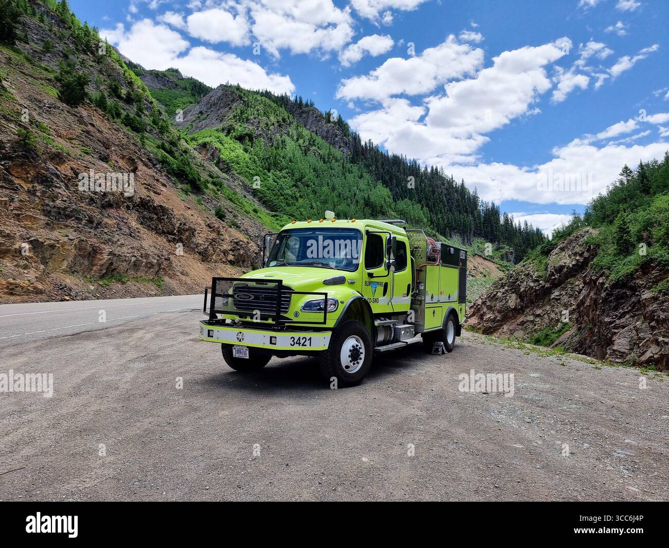 Bright yellow Bureau of Land Management (BLM) fire truck for ultra-fast response, parked in mountainous area in Colorado - Smartphone Captured Stock Image