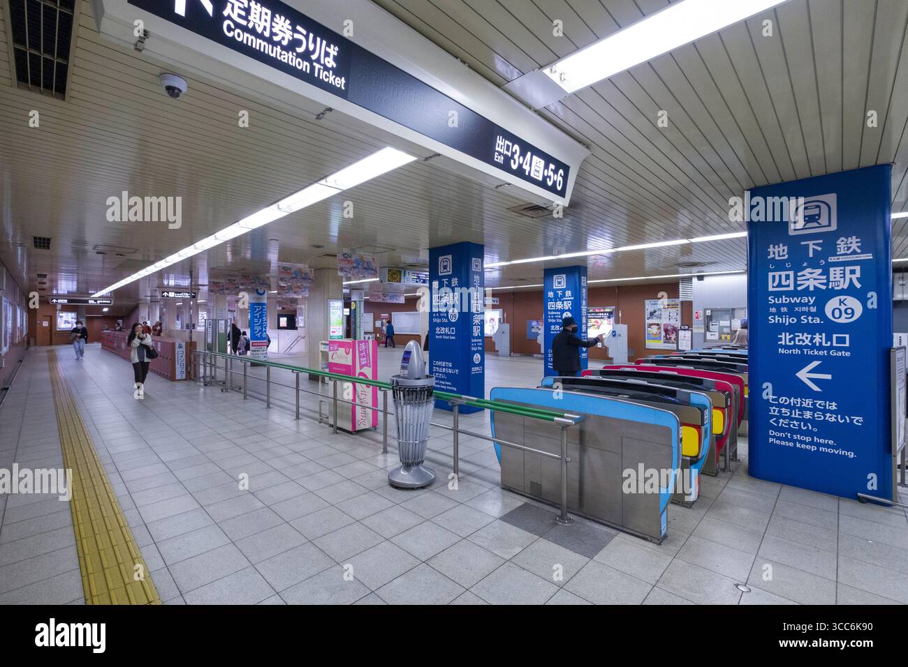 An empty subway station with turnstiles and commutation ticket signs at Shijo Station. The station is well-lit and orderly, depicting a typical urban Stock Photo