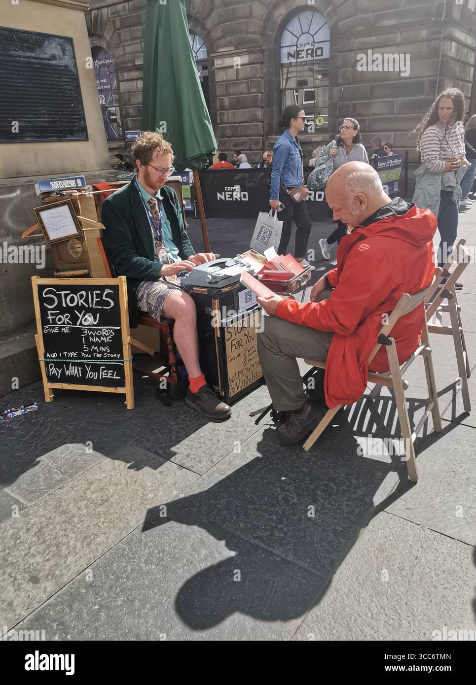Street scenes and acts distributing flyers for their shows on the Royal Mile in Edinburgh during the world famous Edinburgh Fringe Festival. - Smartphone Captured Stock Image