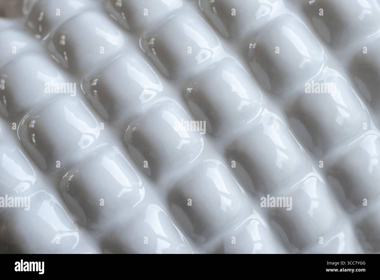 Shiny and reflective white ceramic object with 3D effect projections. Abstract backgrounds Stock Photo