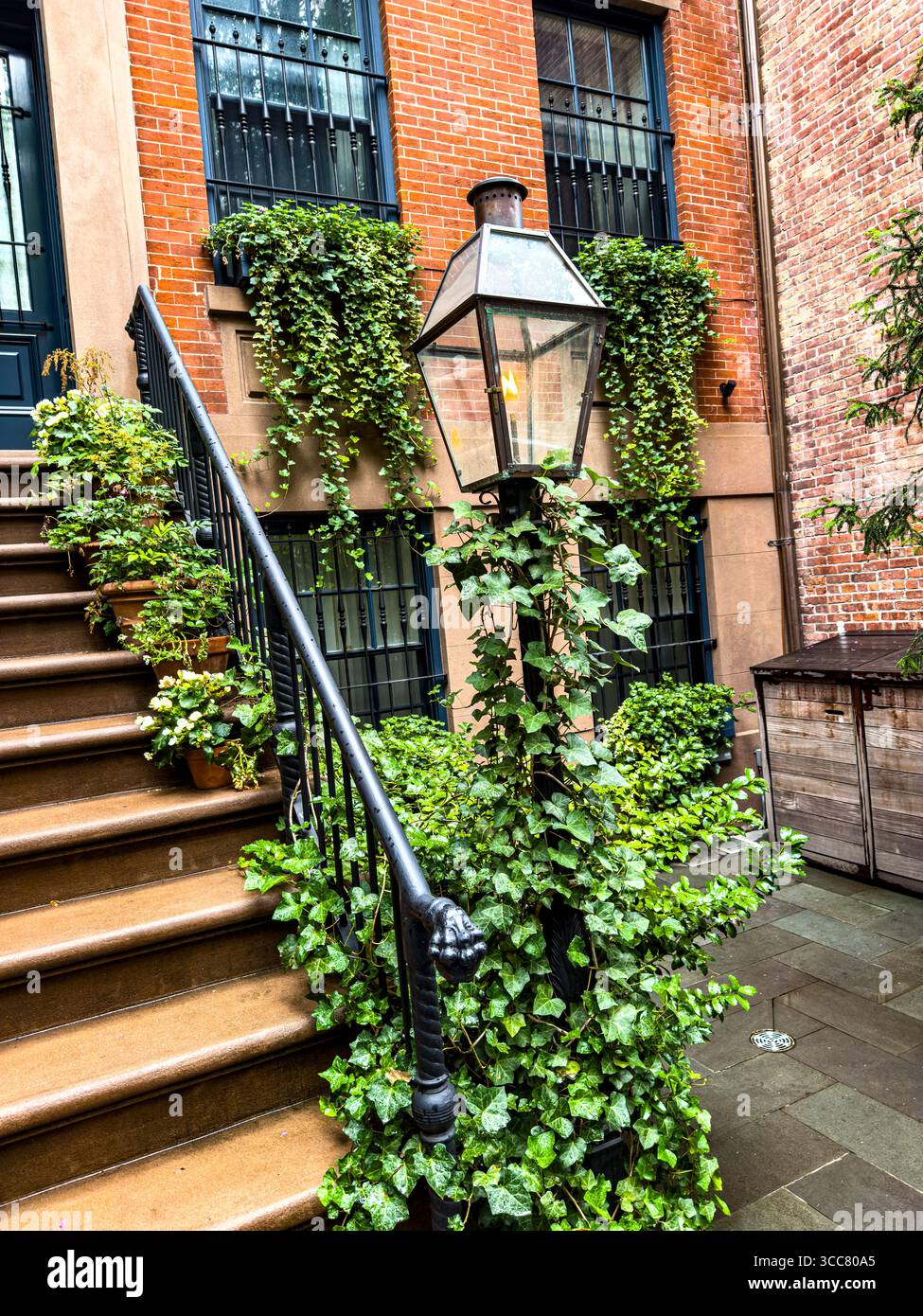 Gas lamp in front of a beautiful brick townhouse on 13th Street in Greenwich Village, New York City, New York, USA - Smartphone Captured Stock Image