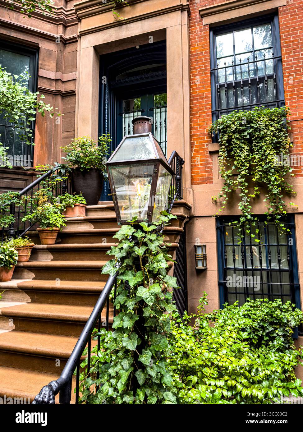 Gas lamp in front of a beautiful brick townhouse on 13th Street in Greenwich Village, New York City, New York, USA - Smartphone Captured Stock Image