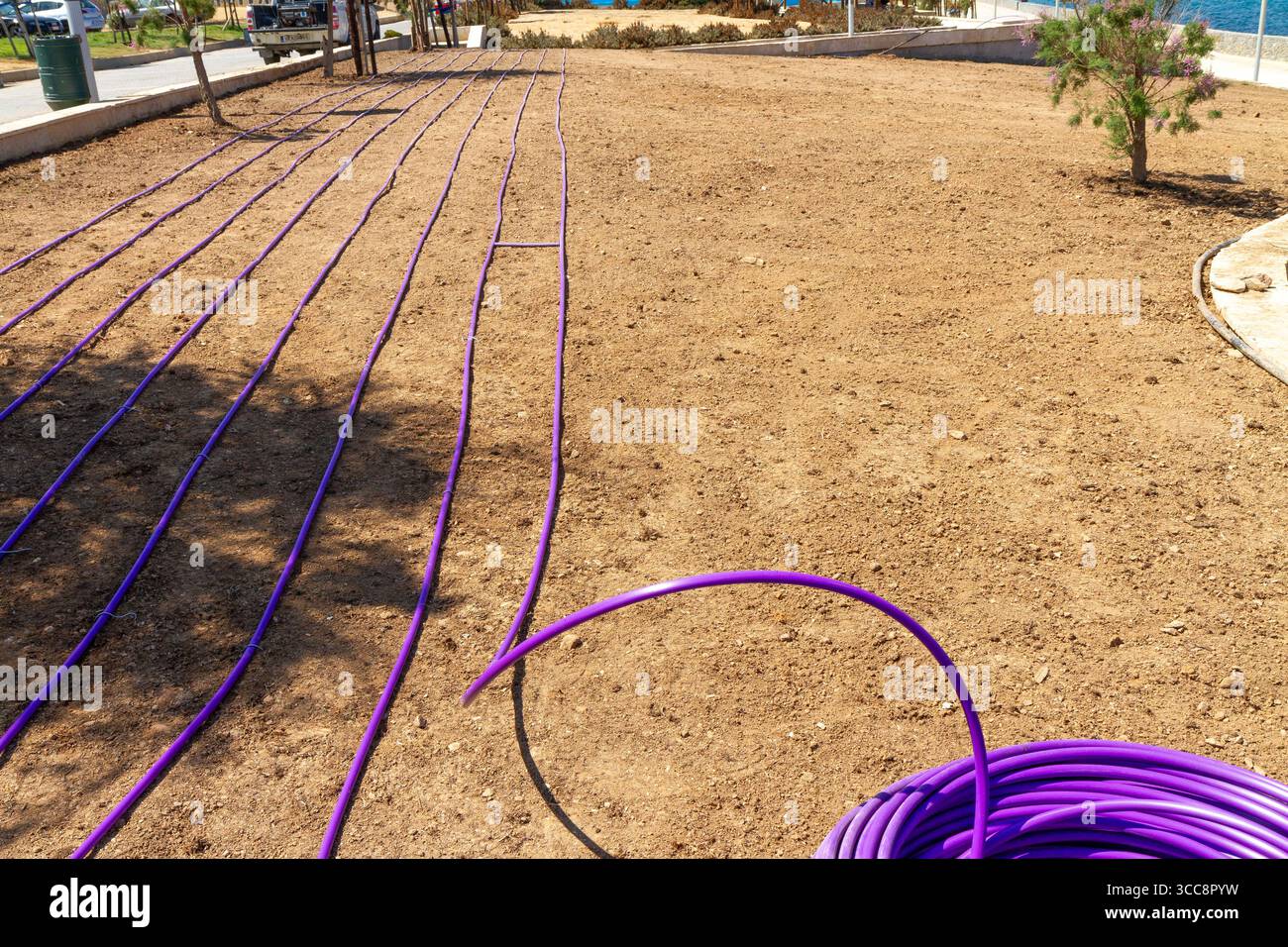Installing automated watering system in garden field Stock Photo - Alamy