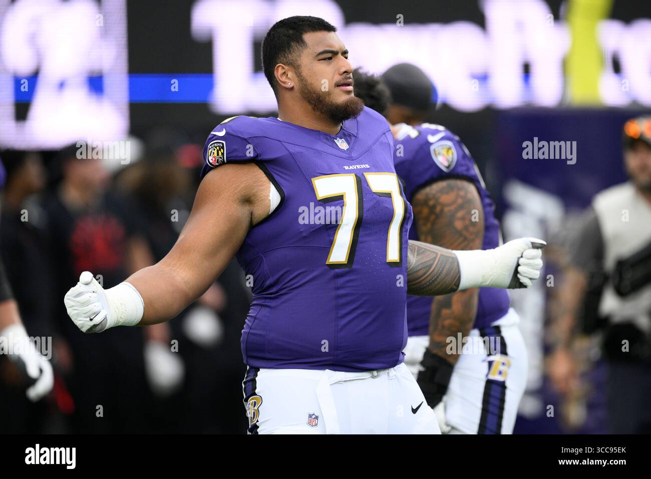 Baltimore Ravens guard Daniel Faalele (77) works out before a preseason ...