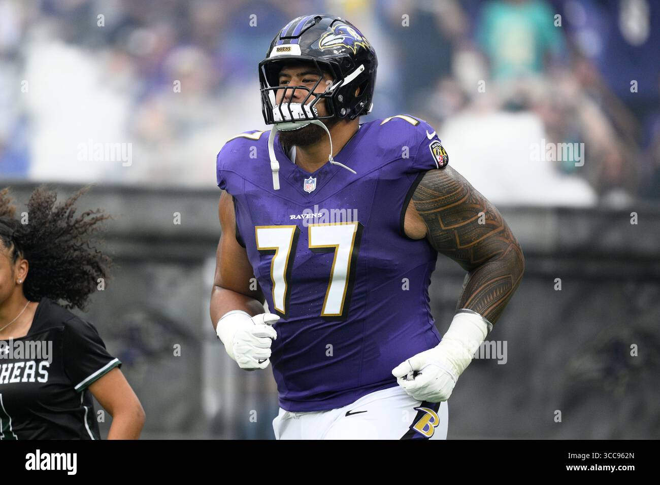 Baltimore Ravens guard Daniel Faalele (77) takes to the field before an ...