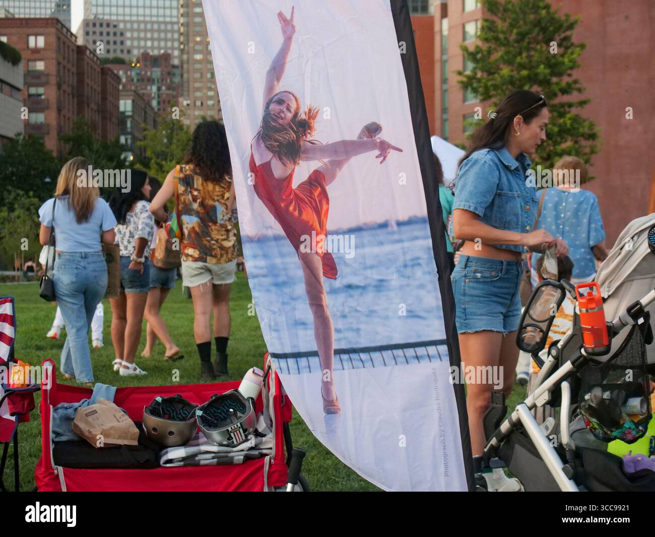 New York, New York, USA. 9th Aug, 2025. The scene on the lawn at the opening of the annual.Battery Dance Festival on the newly opened resigned flood barrier.Wagner Park opposite the Statue of Liberty in Lower Manhattan. (Credit Image: © Milo Hess/ZUMA Press Wire) EDITORIAL USAGE ONLY! Not for Commercial USAGE! Stock Photo