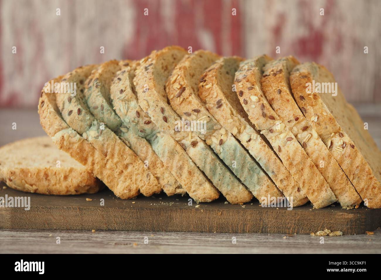 Mold bread on wooden board with rustic background Stock Photo