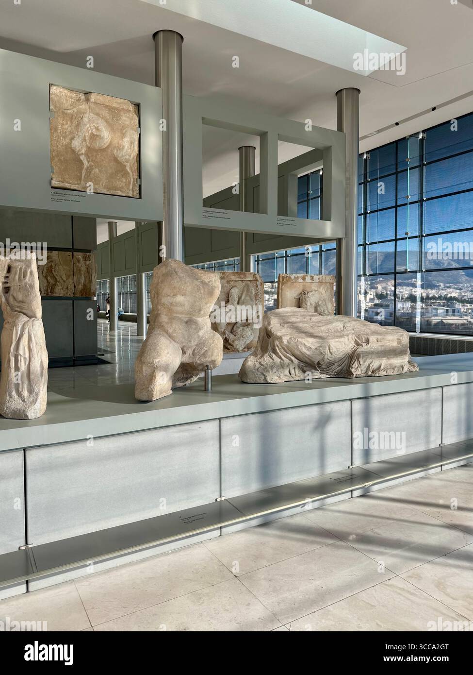 Interior views of the Acropolis Museum in Athens, Greece, featuring Parthenon marble sculptures and friezes. - Smartphone Captured Stock Image