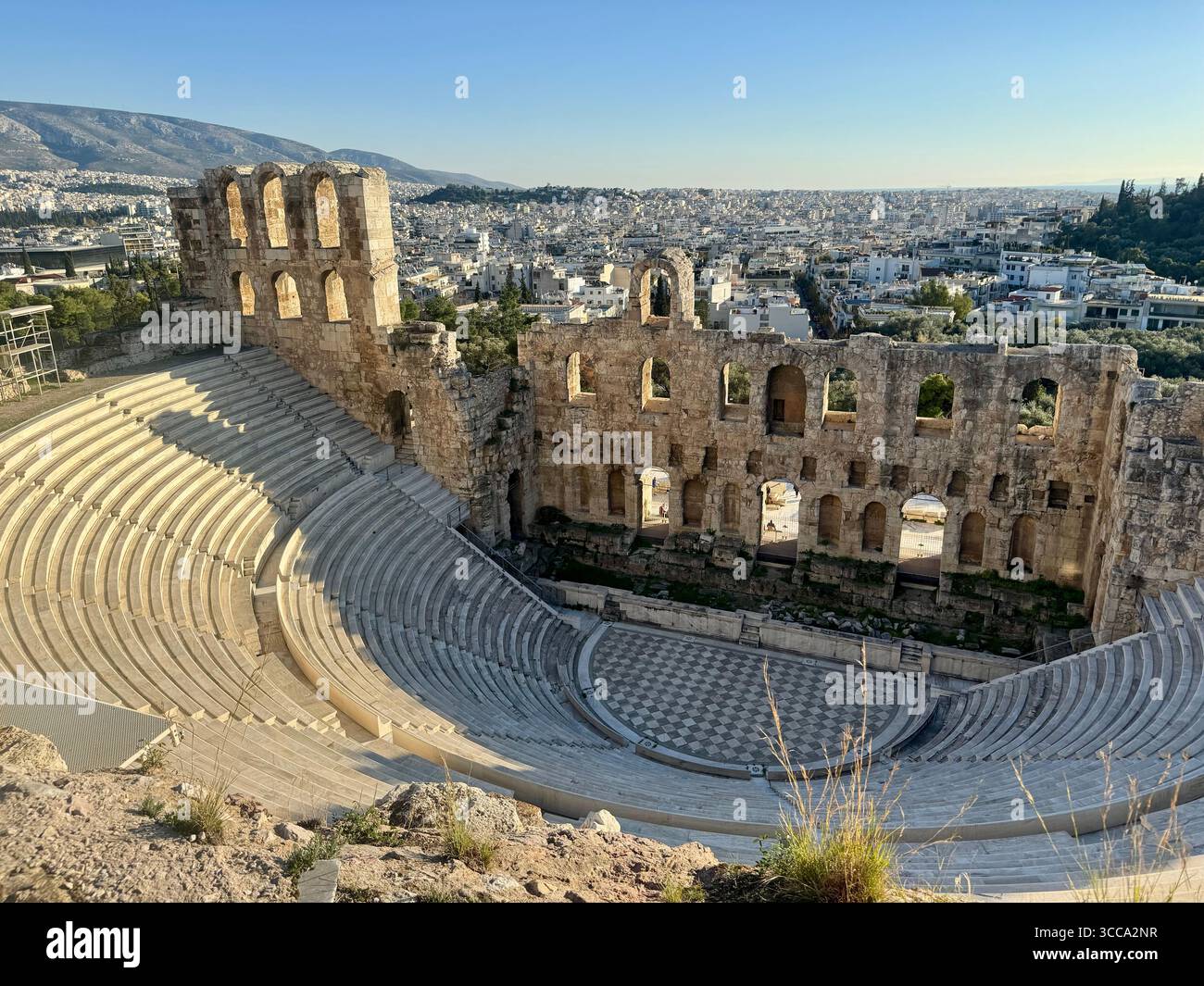 Odeon of Herodes Atticus ancient stone theater in Athens with panoramic city view - Smartphone Captured Stock Image