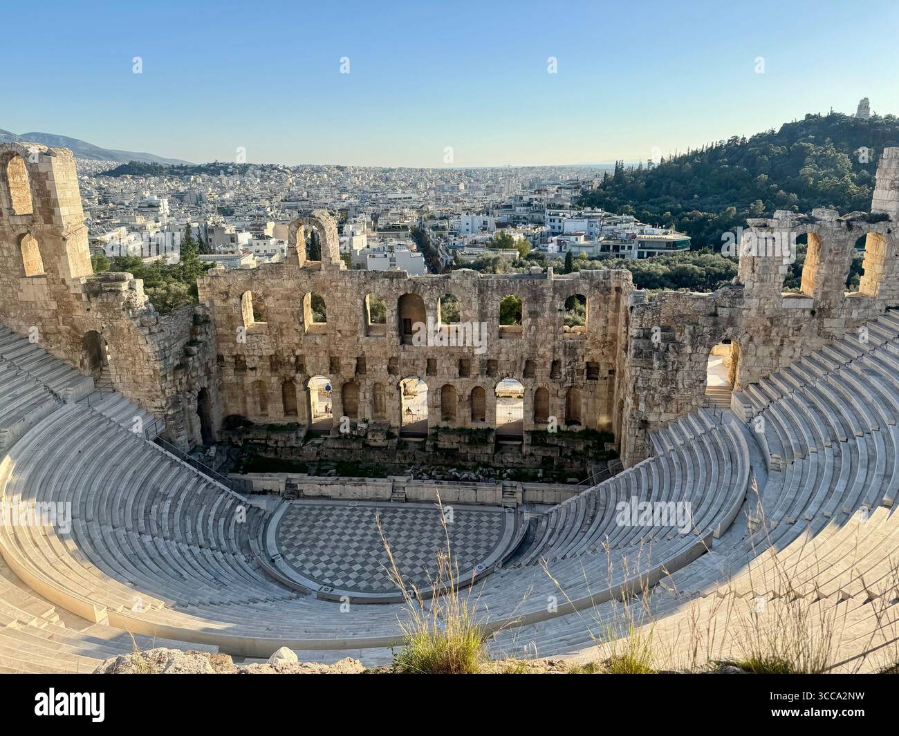 Odeon of Herodes Atticus ancient stone theater in Athens with panoramic city view - Smartphone Captured Stock Image