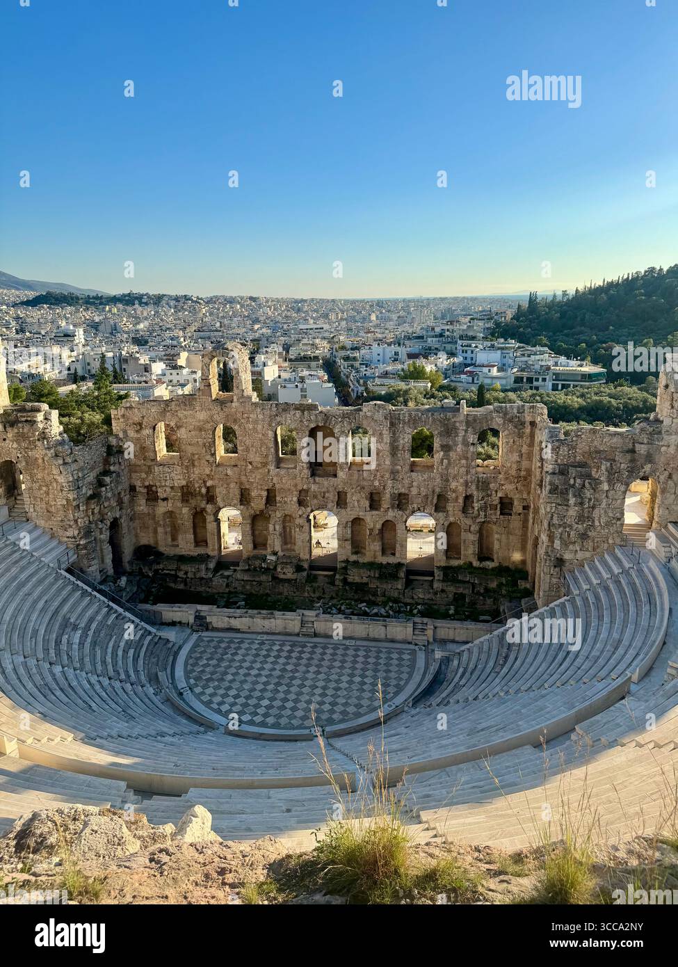 Odeon of Herodes Atticus ancient stone theater in Athens with panoramic city view - Smartphone Captured Stock Image