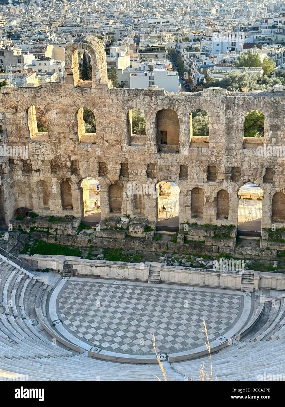 Odeon of Herodes Atticus ancient stone theater in Athens with panoramic city view - Smartphone Captured Stock Image