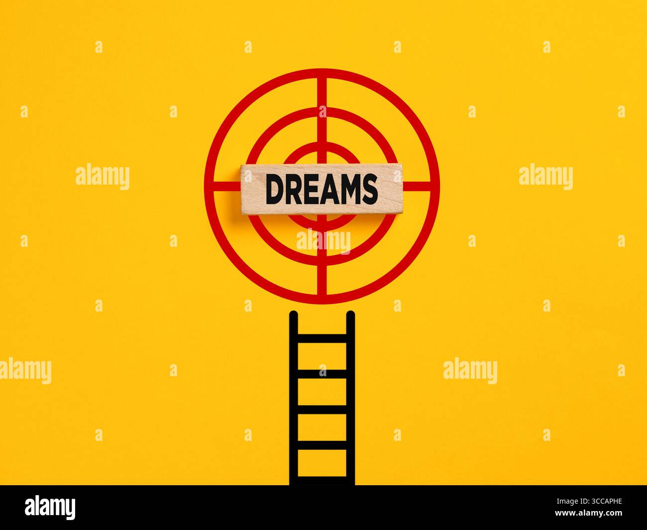 Realize a dream concept. Ladder leading to a target with a wooden block with the word dreams in the center on a yellow background Stock Photo