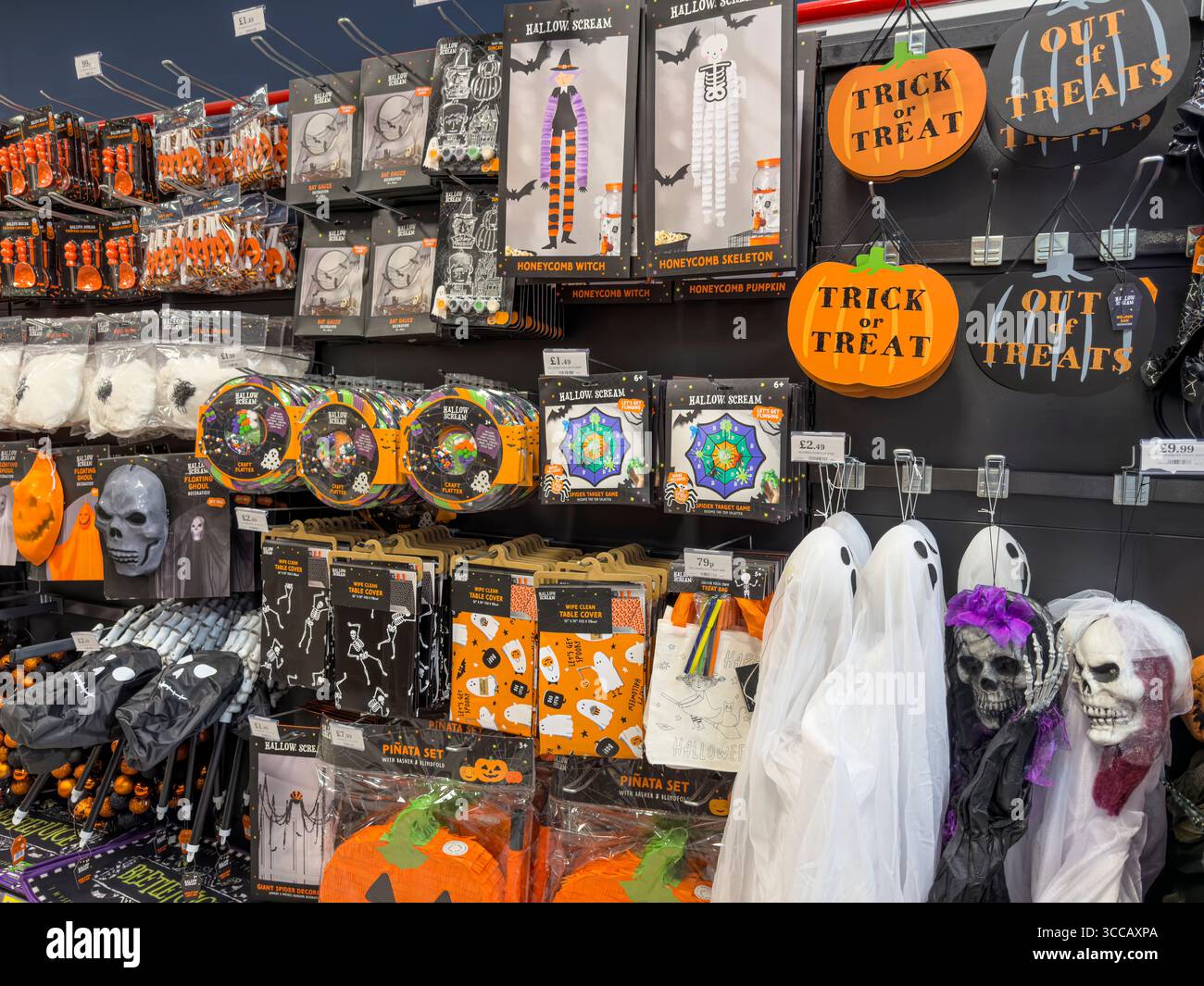 Halloween costumes, decorations, and party supplies on sale in seasonal display at UK department store – spooky October retail merchandising - Smartphone Captured Stock Image