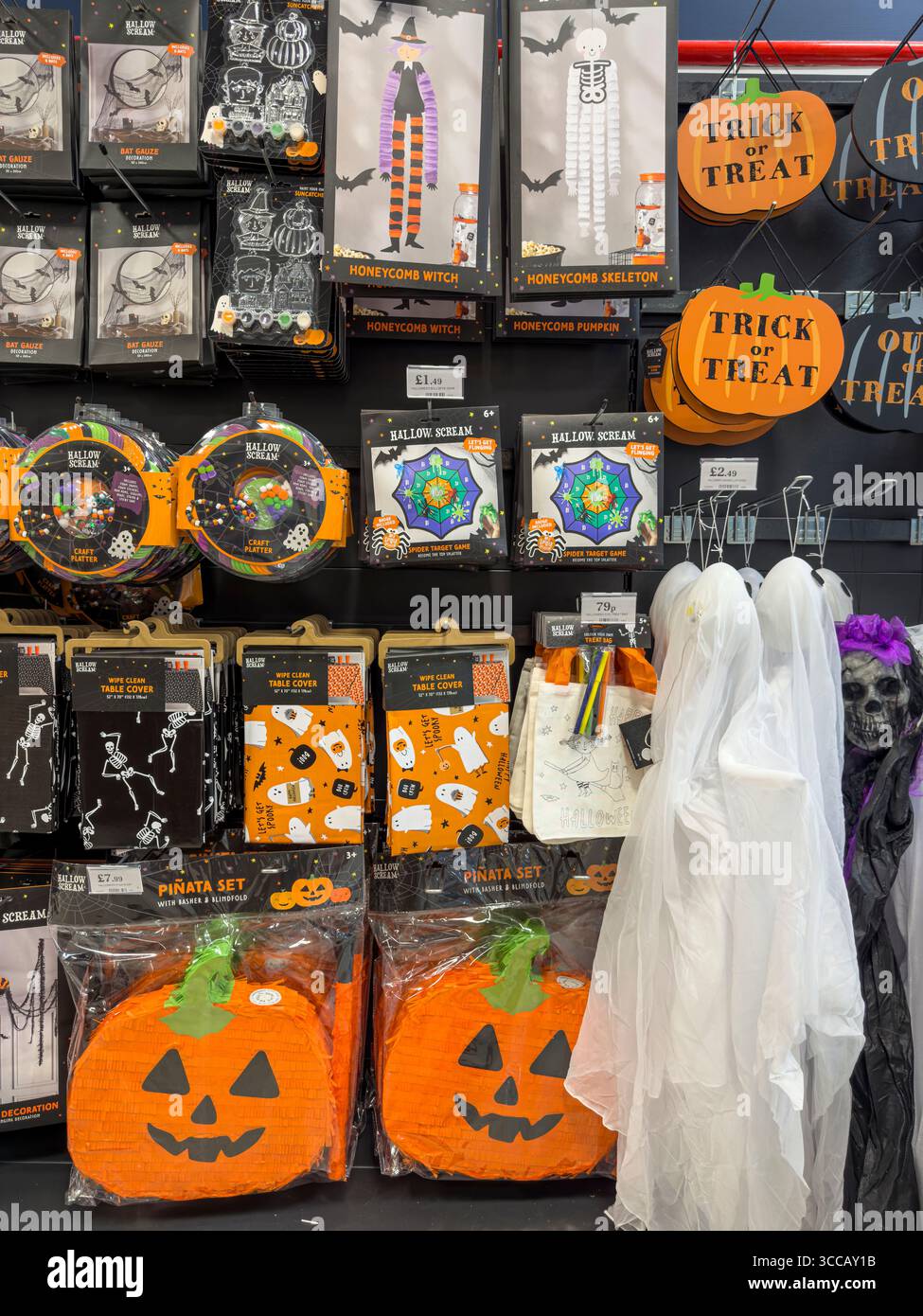 Halloween costumes, decorations, and party supplies on sale in seasonal display at UK department store – spooky October retail merchandising - Smartphone Captured Stock Image