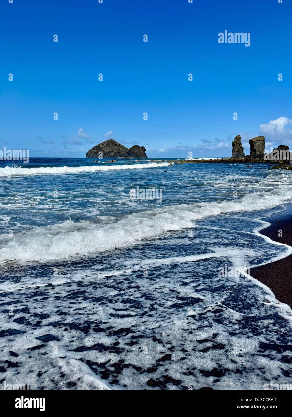 Mosteiros Beach in the Azores, Portugal, with the iconic Mosteiros islets in the background on a clear summer day. - Smartphone Captured Stock Image