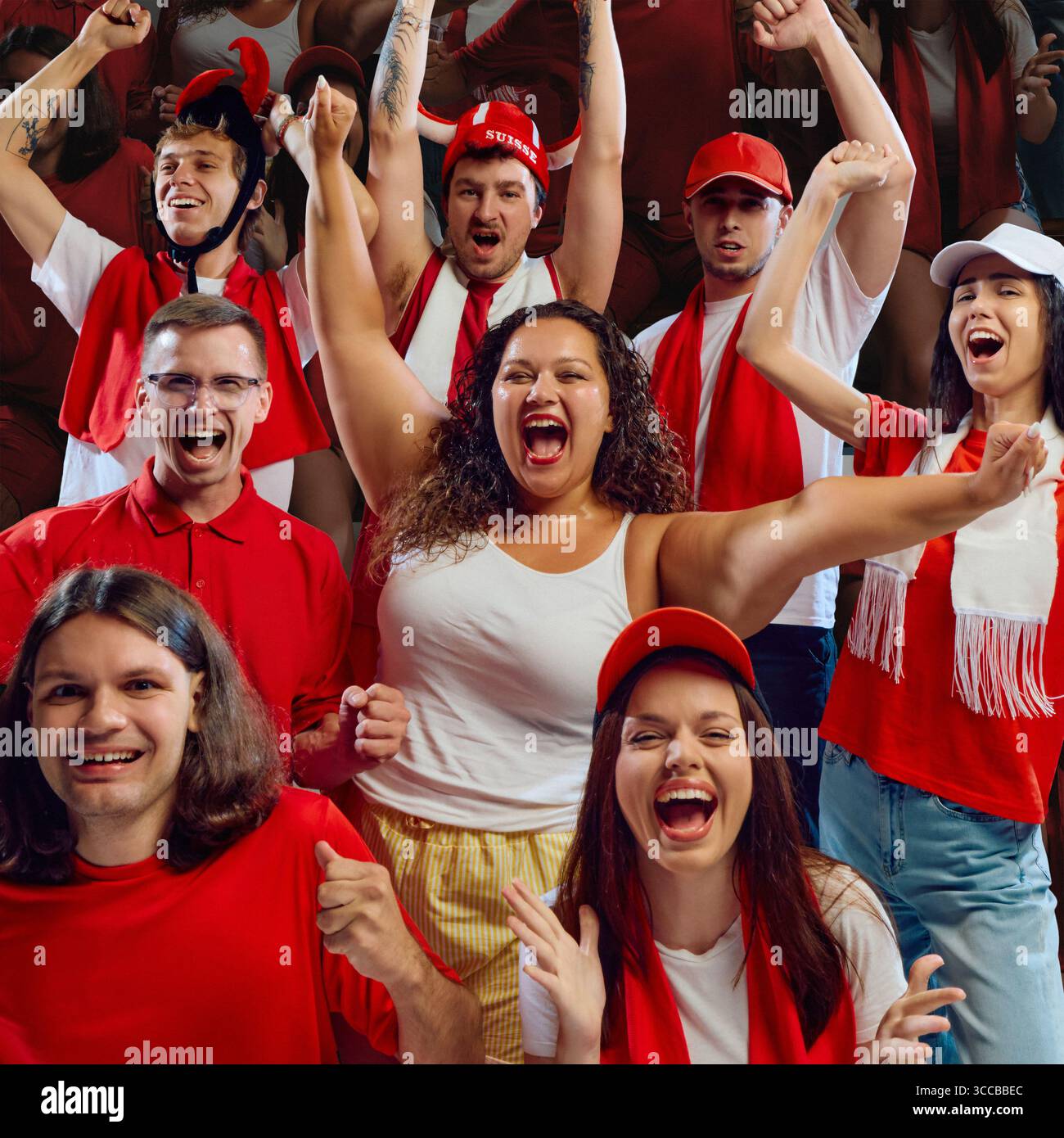 Diverse group of sports fans celebrating in red team colors Stock Photo ...