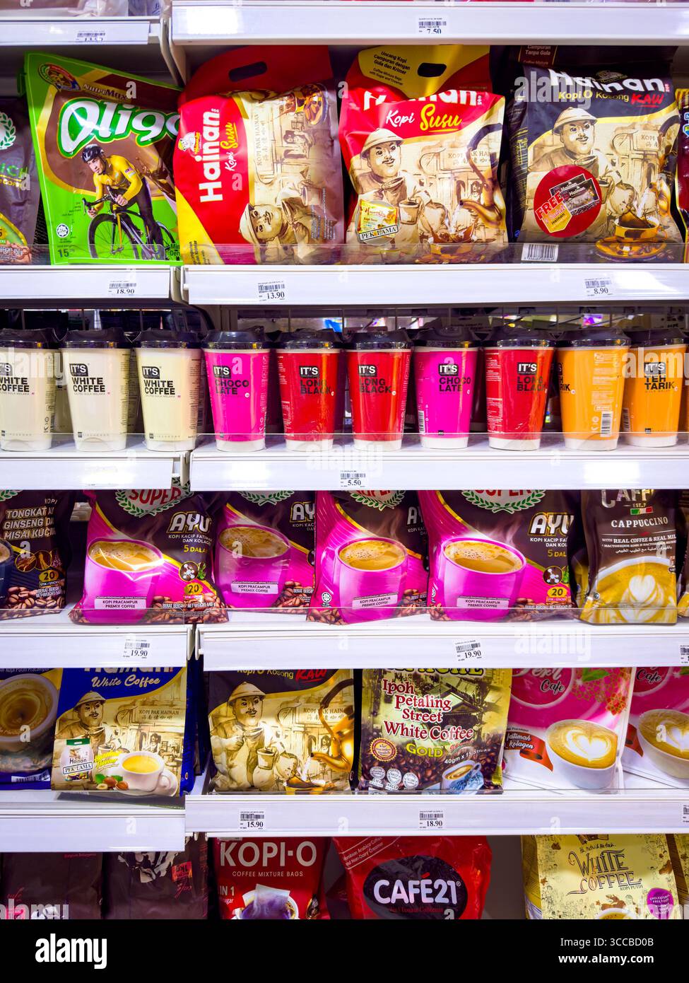 A grocery store shelf filled with a variety of instant premix coffee Kopi and beverage products in colourful packaging Kuala Lumpur Malaysia - Smartphone Captured Stock Image