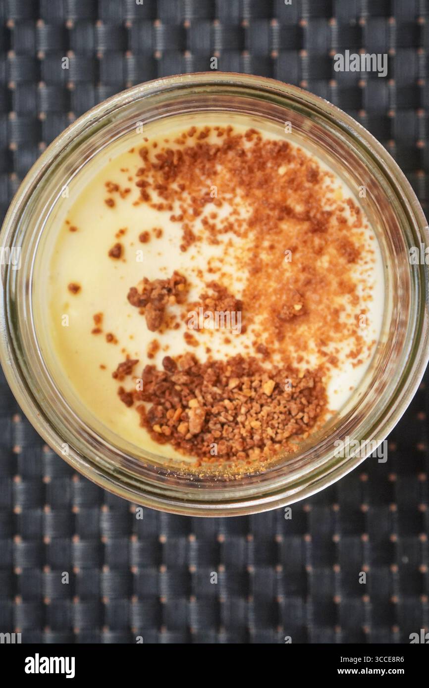 Caramelized custard in a ramekin with a browned surface ready for serving as dessert. Stock Photo