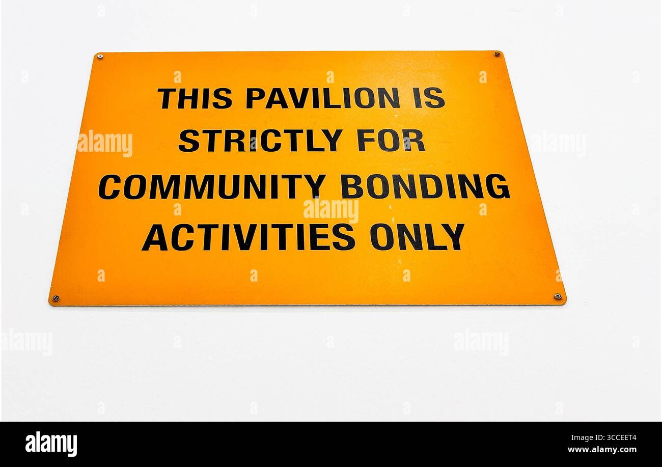 Orange sign with text indicating that the pavilion is strictly for community bonding activities only, singapore art museum - Smartphone Captured Stock Image