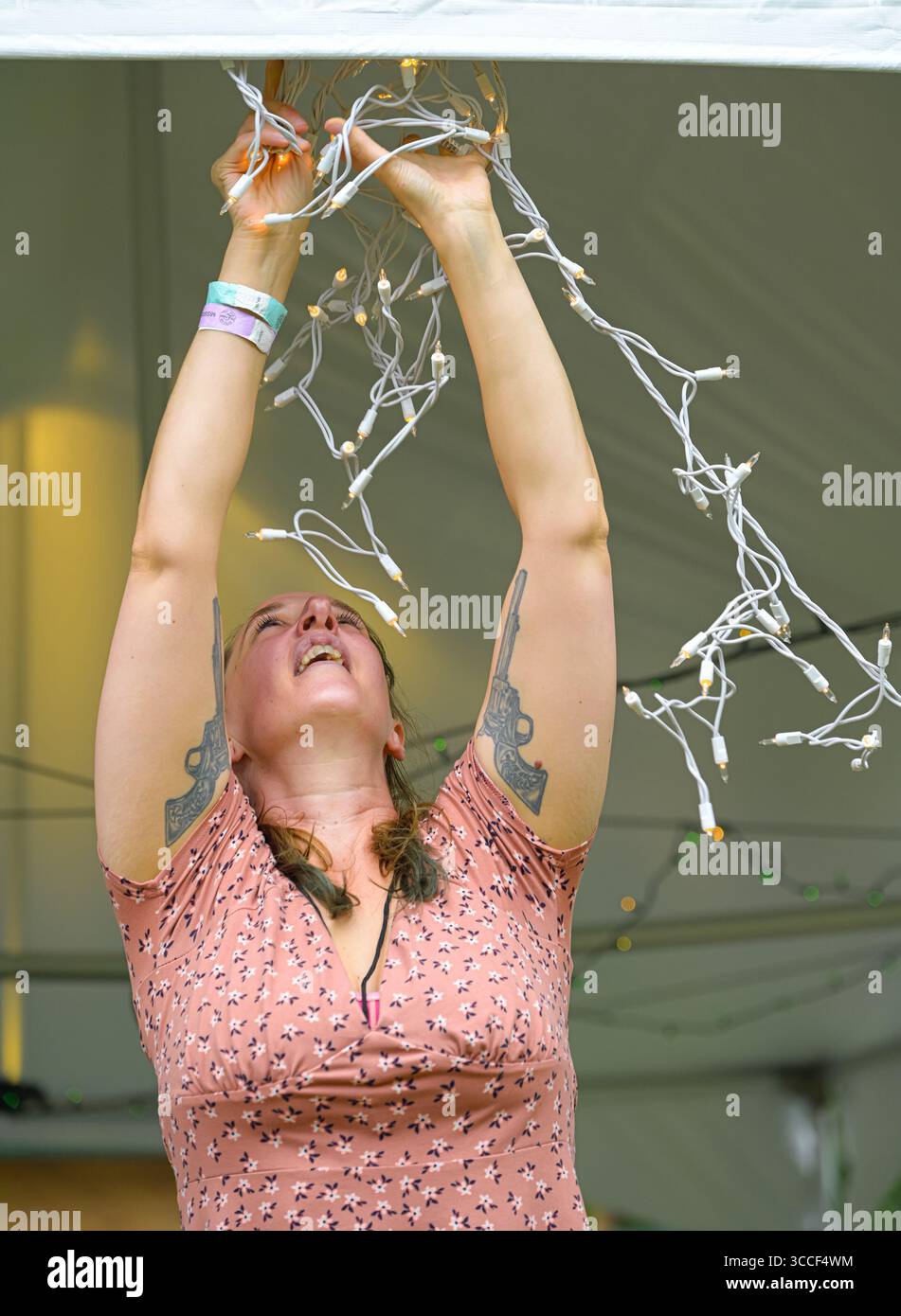 Woman putting up fairy lights Stock Photo