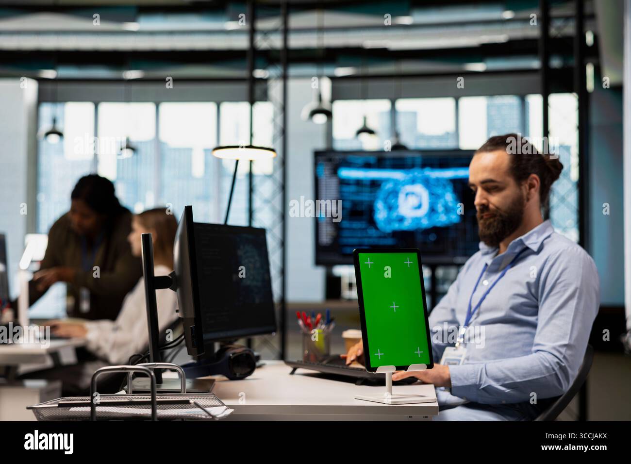 Startup office engineer using green screen tablet, developing artificial intelligence models for business analytics. IT specialist using mockup device, running simulations for AI forecasting Stock Photo