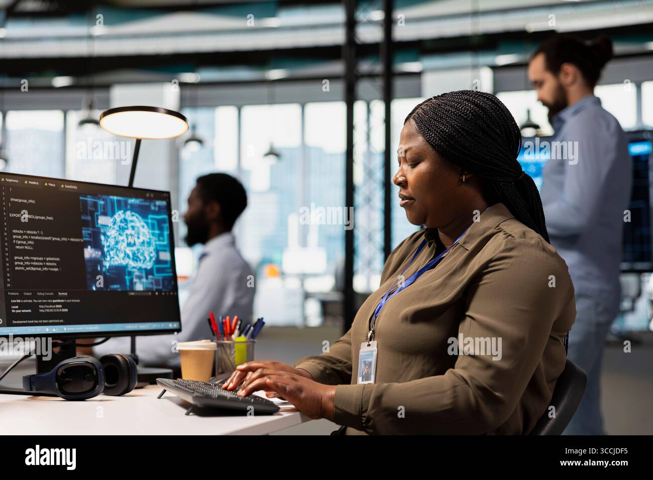Software engineer using AI automation in tech workspace, building digital solutions. African american IT specialist working on PC to identify and fix bugs using artificial intelligence tools Stock Photo