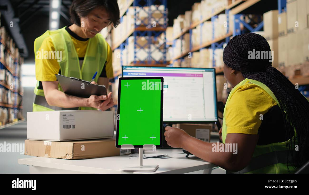 Employee reviews copy space monitor in the storage room for data entry ...