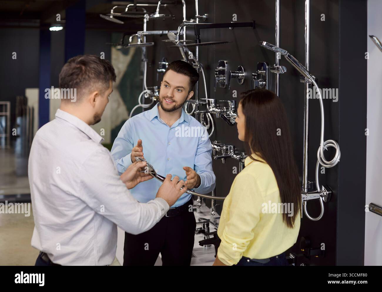 Retail employee helping client choose hi-res stock photography and ...
