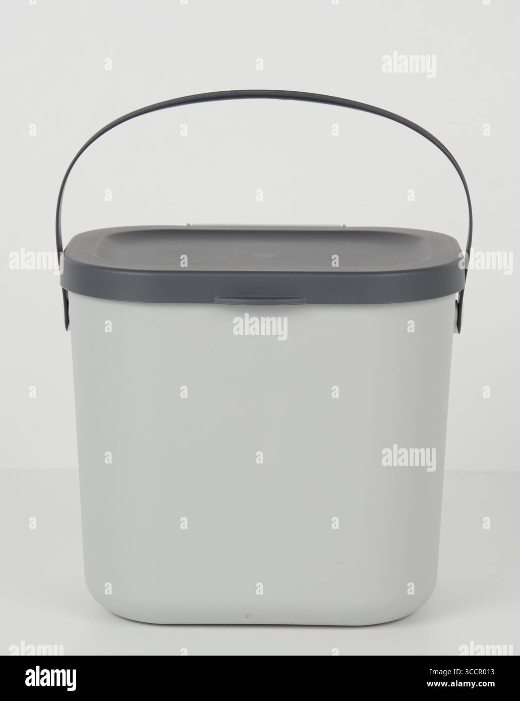 Gray plastic bucket with handle isolated nature background with ...