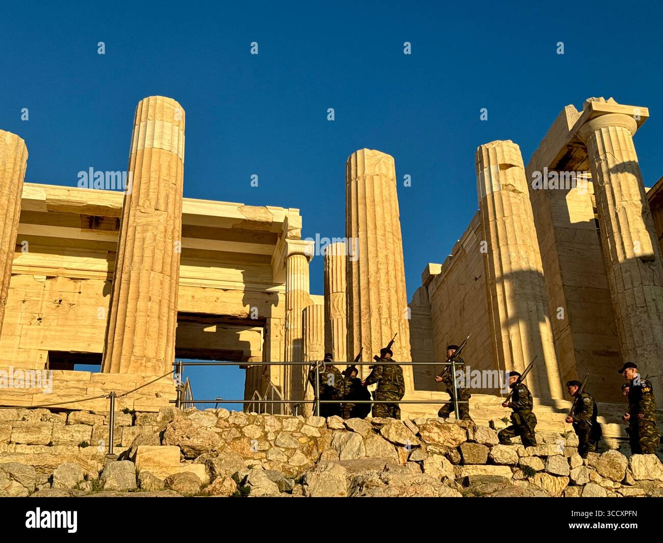 The Greek military conducts a ceremony at sunset to inspect the interior of the Acropolis and guard the flag, an important cultural tradition. - Smartphone Captured Stock Image