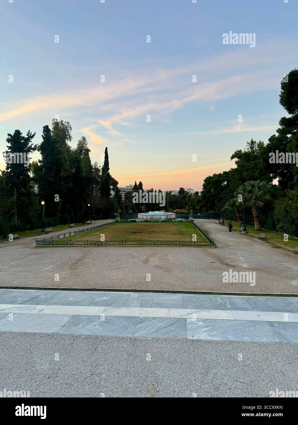Zappeion Garden in Athens, Greece, featuring serene pond waters and landscaped walkways during sunset. - Smartphone Captured Stock Image