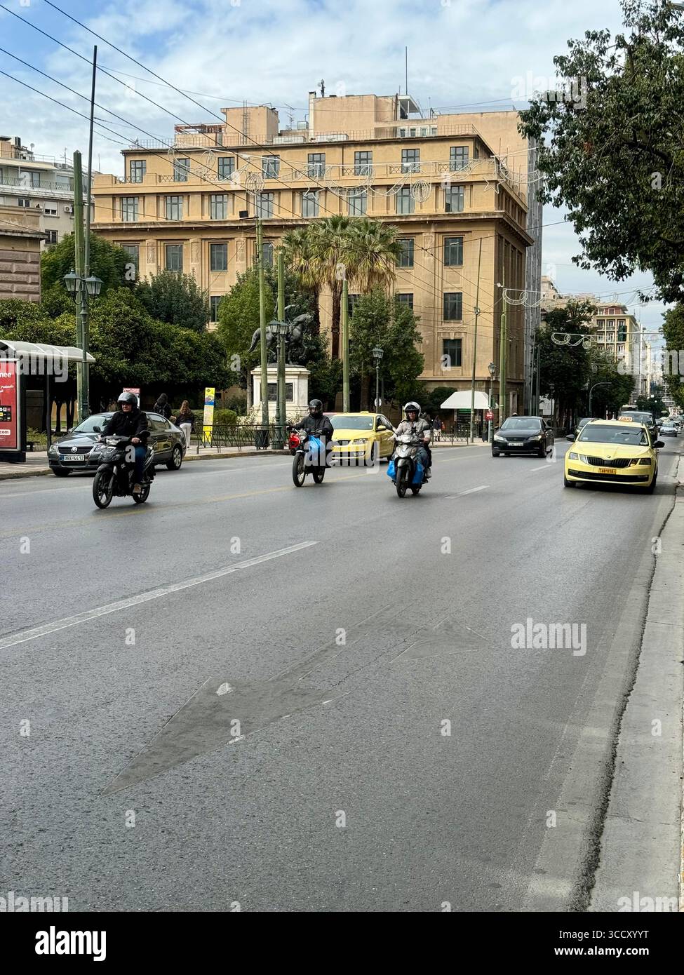 Urban street scene with motorcycles, taxis, and buildings in central Athens, Greece. - Smartphone Captured Stock Image Urban street scene with motorcycles, taxis, and buildings in central Athens, Greece. - Smartphone Captured Stock Image