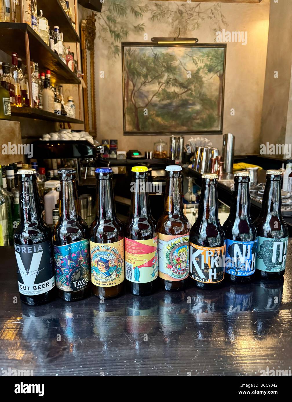 Selection of Greek craft beer bottles displayed on a bar counter. - Smartphone Captured Stock Image