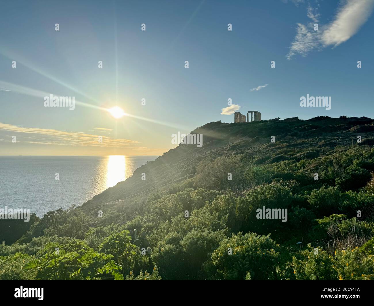 Temple of Poseidon at Cape Sounion during sunset with the sun reflecting on the Aegean Sea. - Smartphone Captured Stock Image